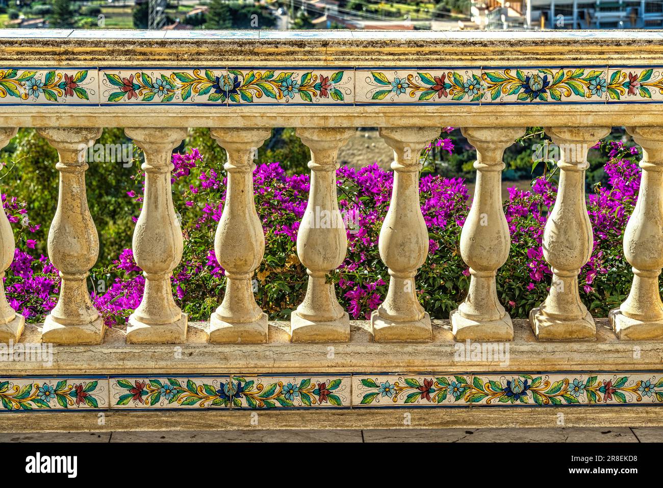 Carved handrail with ceramic pattern and surmounted by a blue basin with a cactus in the city Santo Stefano di Camastra Stock Photo