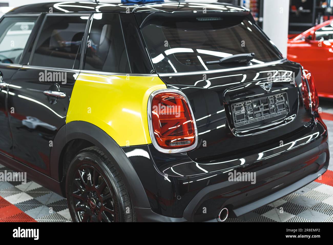 05.17.2023 Warsaw, Poland. Back view of a black Mini Cooper during car  wrapping process. Changing colour from black to neon yellow. High quality  photo Stock Photo - Alamy