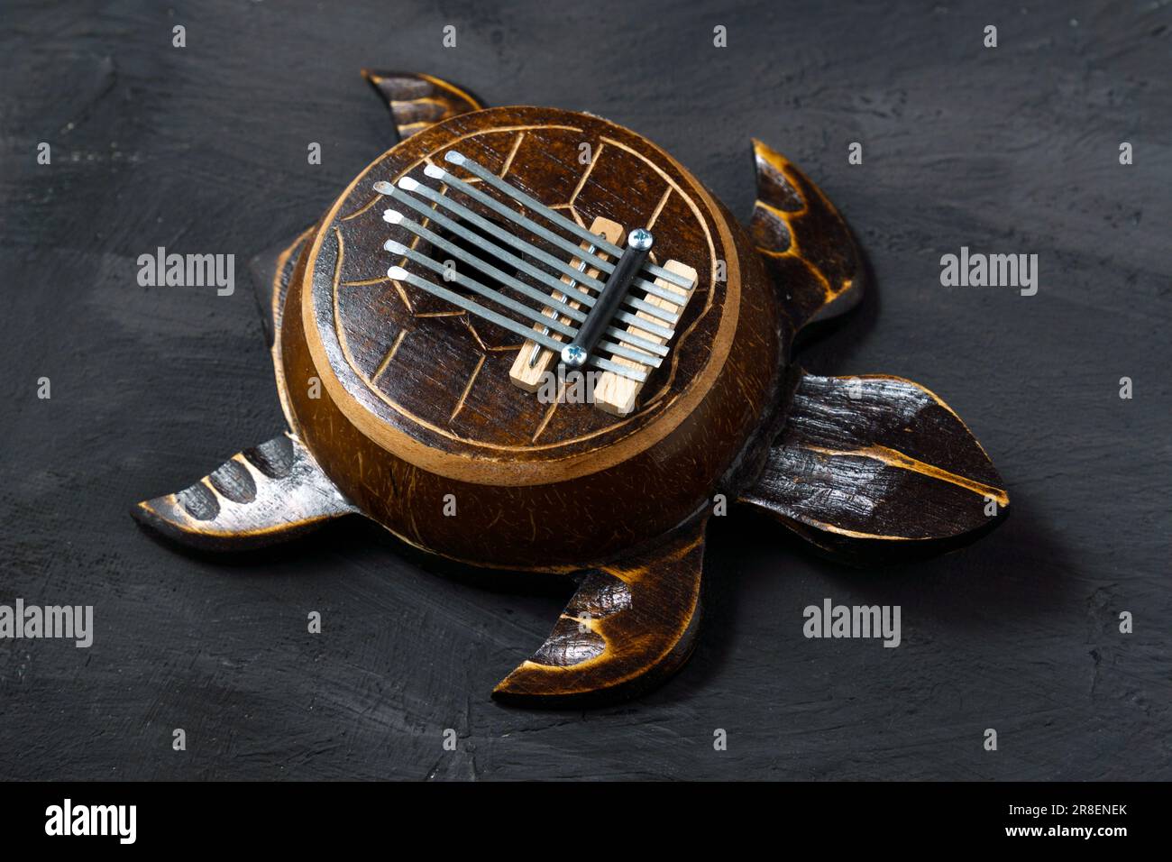 Kalimba turtle on a black background. Traditional musical
