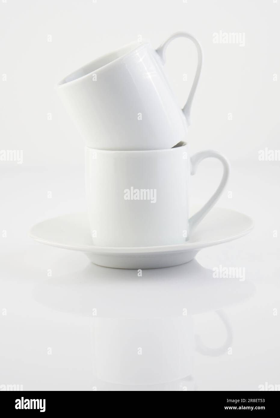 https://c8.alamy.com/comp/2R8ET53/two-white-cups-and-saucers-are-arranged-on-a-stacked-white-surface-2R8ET53.jpg