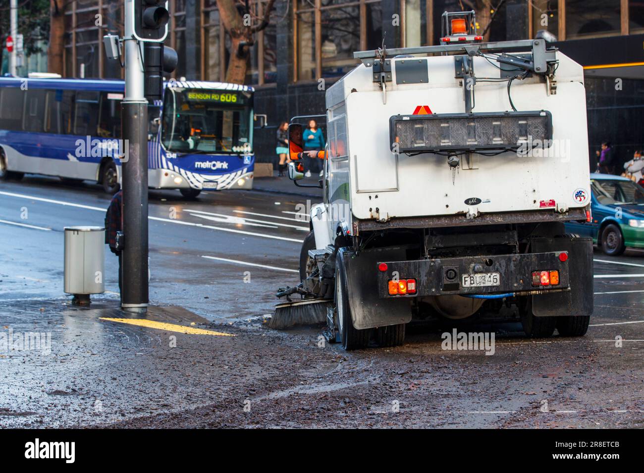 A road sweeper cleans debris from the roadway following a heavy storm, Queen Street, Auckland, New Zealand, Tuesday, July 03, 2012. Stock Photo