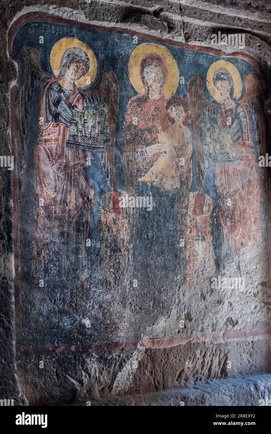 Mother Mary and Jesus icons on the wall of  Gümüşler Monastery and Underground City in the city of Niğde of Turkey country. 05.21.2023 Stock Photo