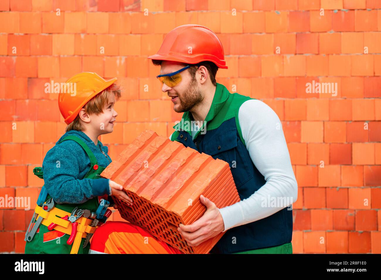 Bricklayer make masonry, builder work with brick layer. Brothers at