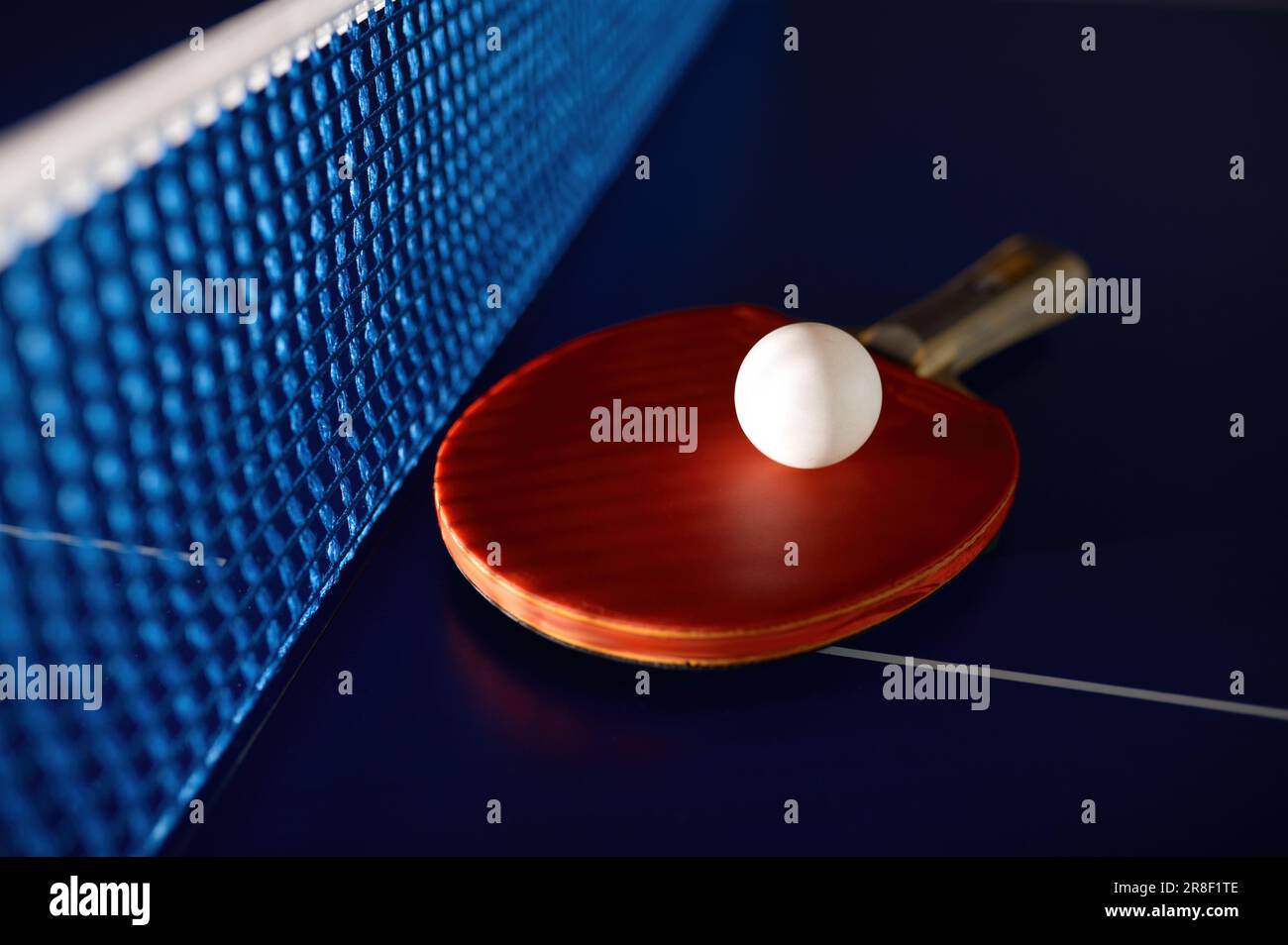 Table tennis equipment on blue ping pong table with grid net Stock Photo Alamy