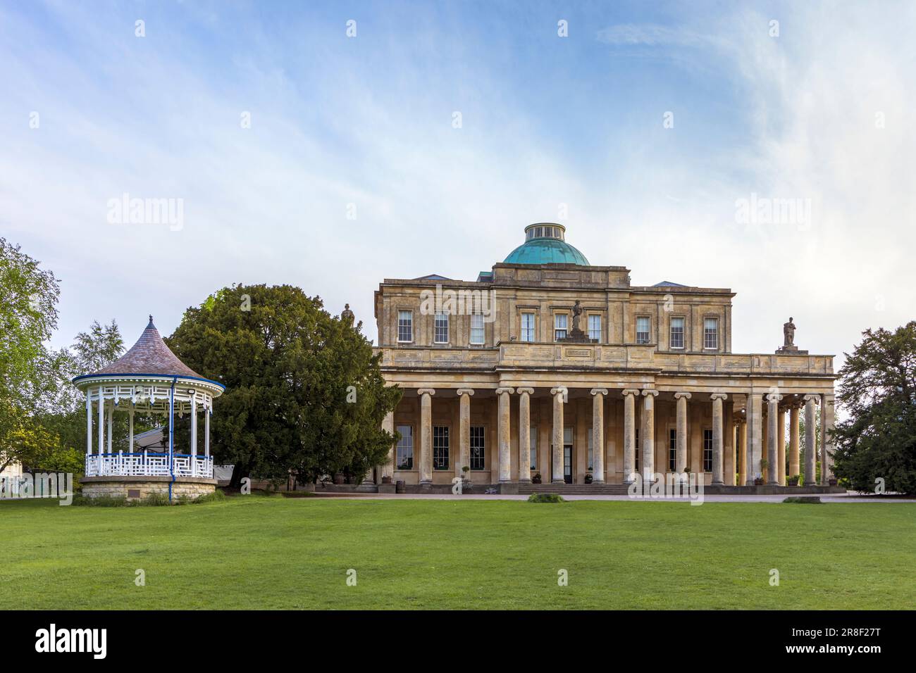 Pittville Pump Room and old spa mineral water buildings in Pittville Park, Cheltenham, Gloucestershire, England Stock Photo