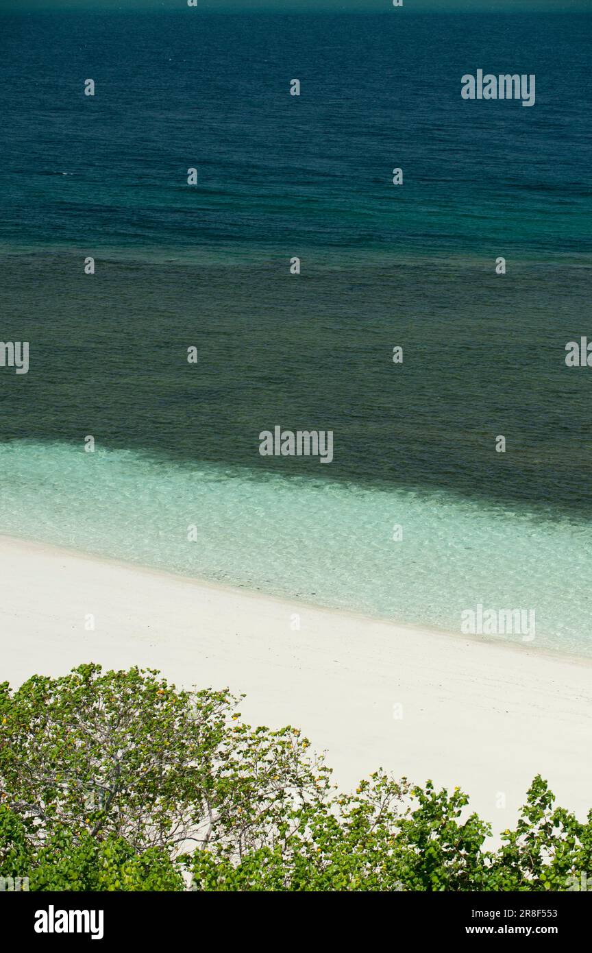 Cristal ocean waves breaking on white sand beach with turquoise emerald water - stock photo Stock Photo