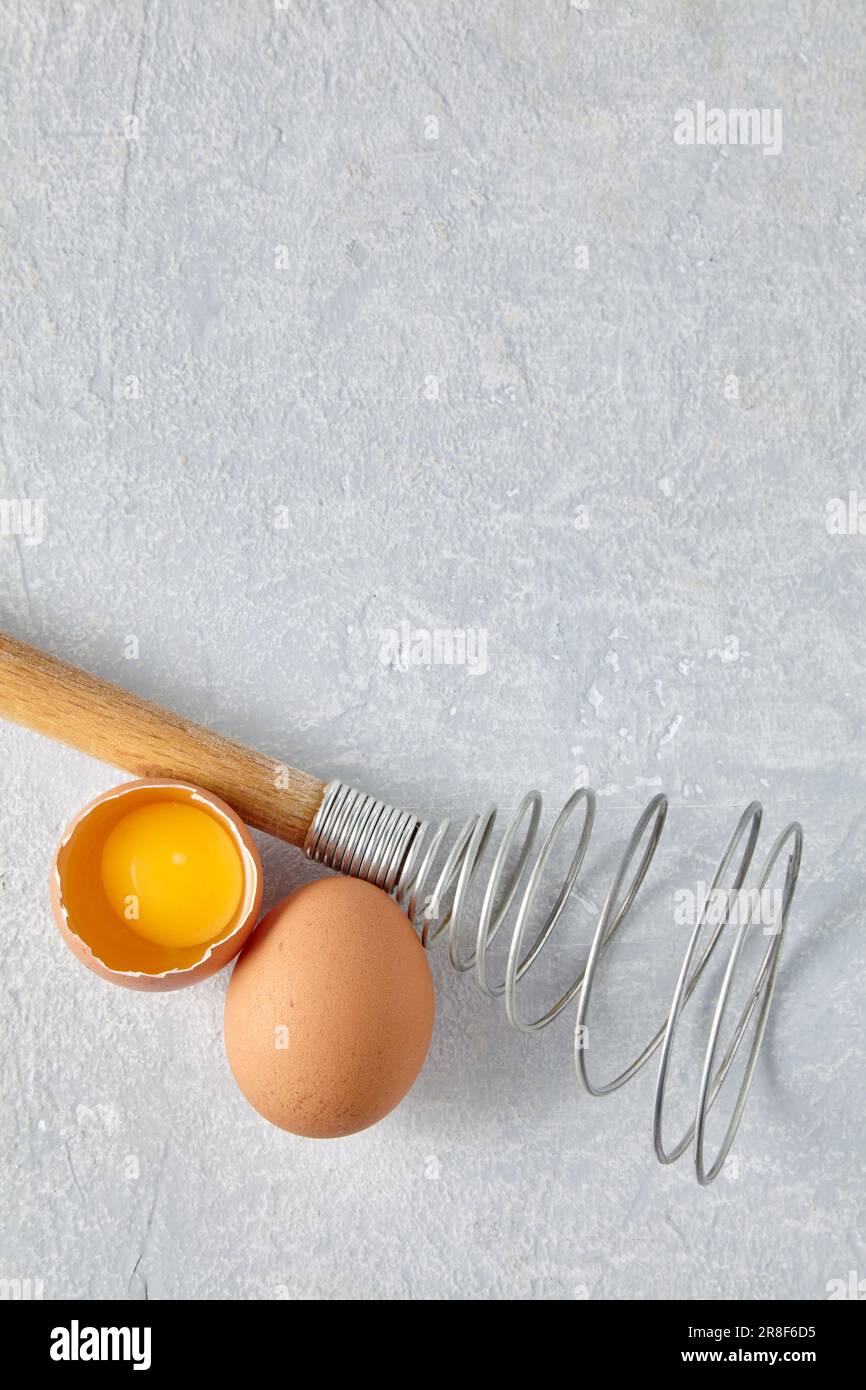 https://c8.alamy.com/comp/2R8F6D5/two-beige-chicken-eggs-and-a-rare-beater-for-beating-cooking-ingredients-isolated-on-white-background-top-view-with-copy-space-2R8F6D5.jpg