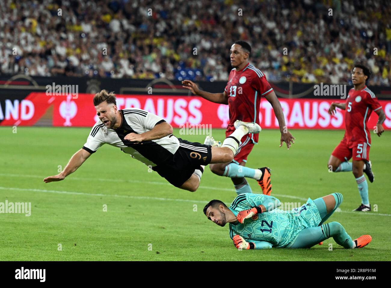 Gelsenkirchen, Germany. 20th June, 2023. Soccer: International match, Germany - Colombia, at the Veltins Arena. Germany's Niclas Füllkrug (l) and Colombia's goalkeeper Camilo Vargas fight for the ball. Credit: Federico Gambarini/dpa/Alamy Live News Stock Photo