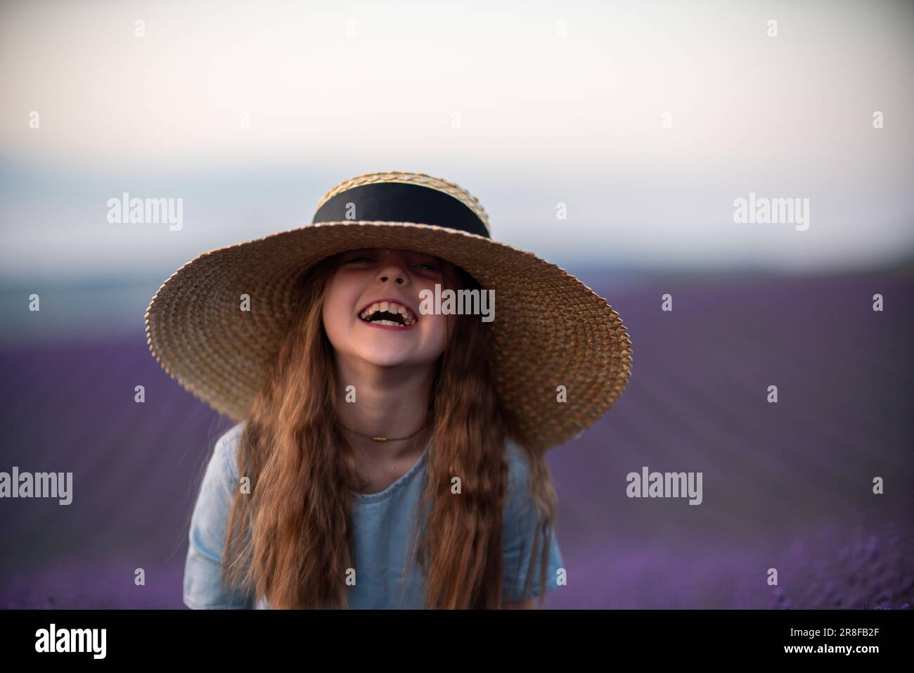 Girl lavender field. Laughing girl in a blue dress with flowing hair in ...