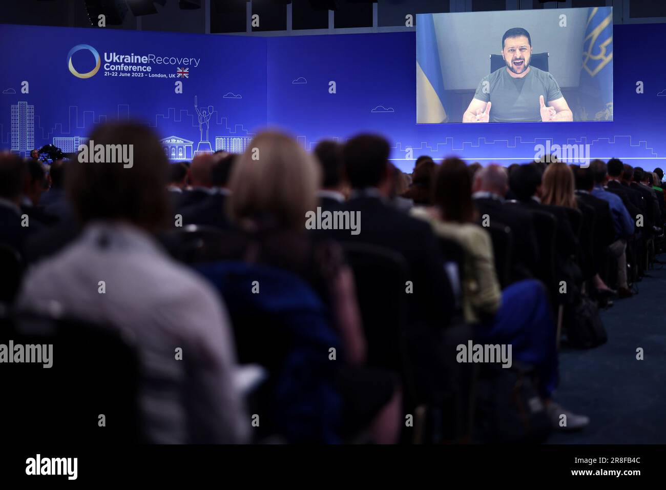 Ukraine's President Volodymyr Zelensky delivers a speech via videolink at the opening session on the first day of the Ukraine Recovery Conference, held at the InterContinental London - O2, in east London. Picture date: Wednesday June 21, 2023. Stock Photo