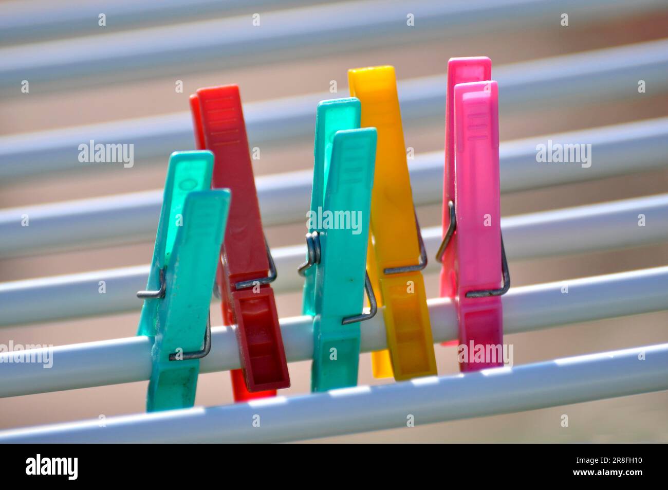 Colourful plastic clothes pegs Stock Photo