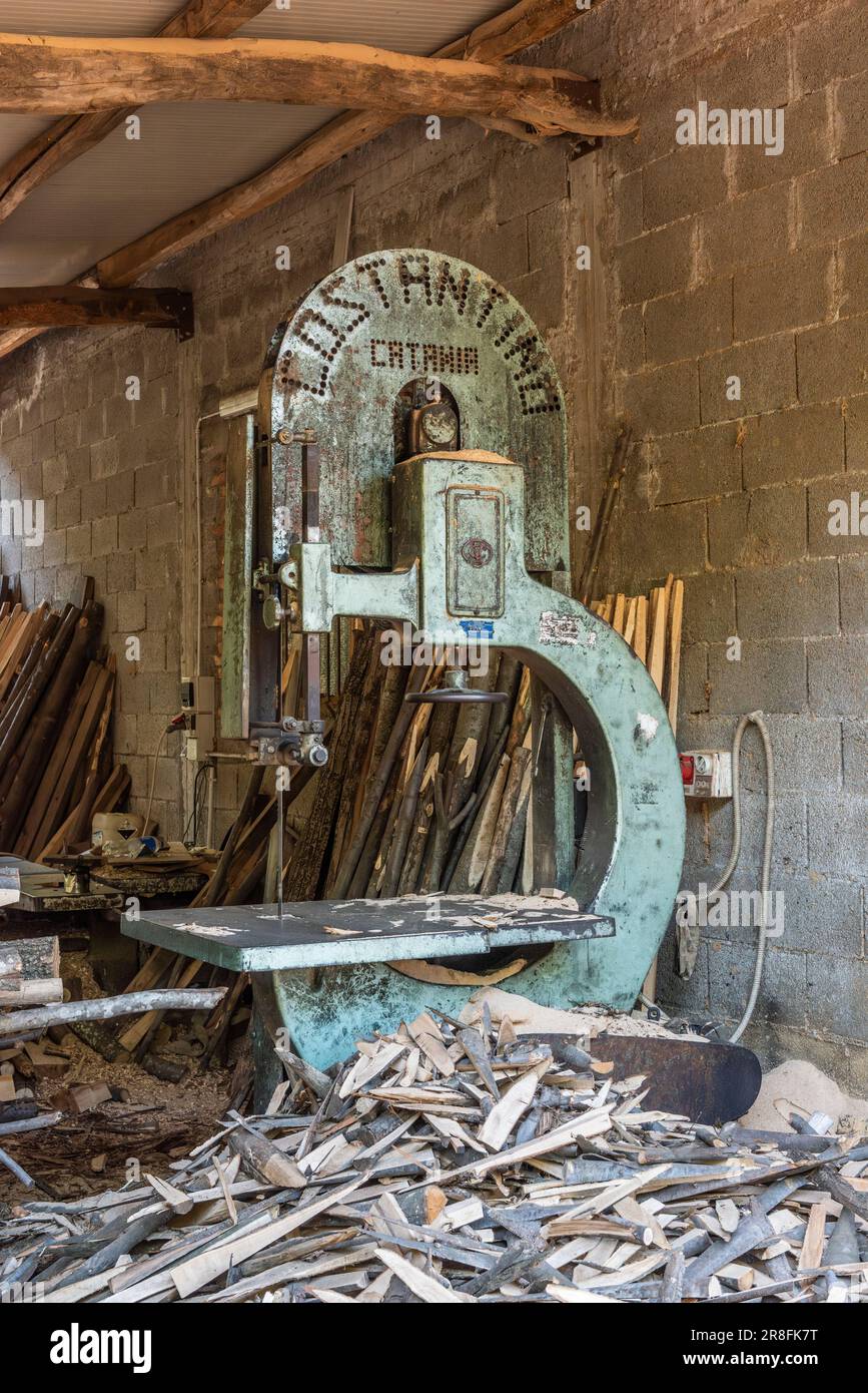 A vintage Costantino bandsaw, still in daily use, in a village timber yard high on the slopes of Mount Etna, Sicily, Italy Stock Photo