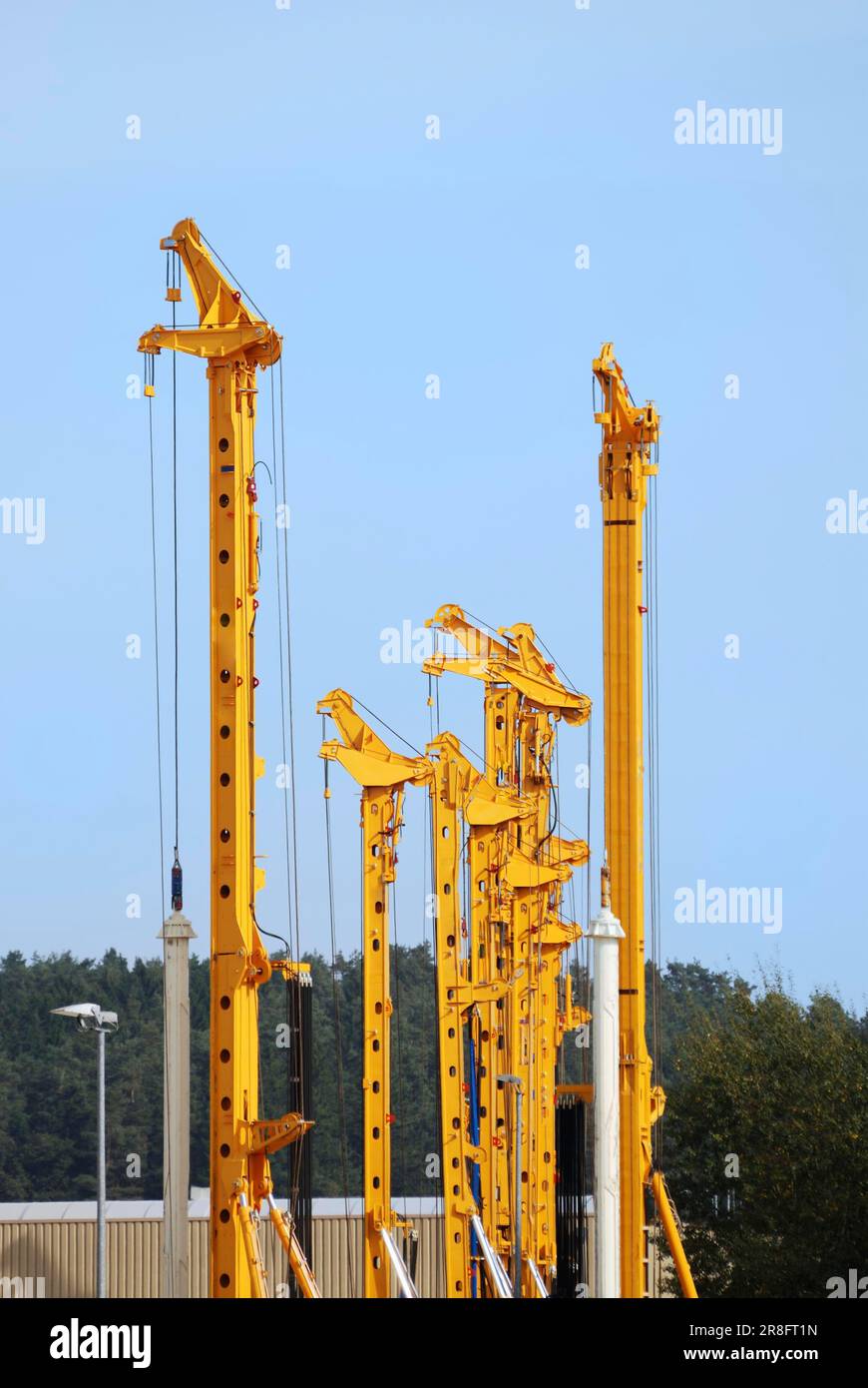 Construction site with high yellow drilling rigs Stock Photo - Alamy