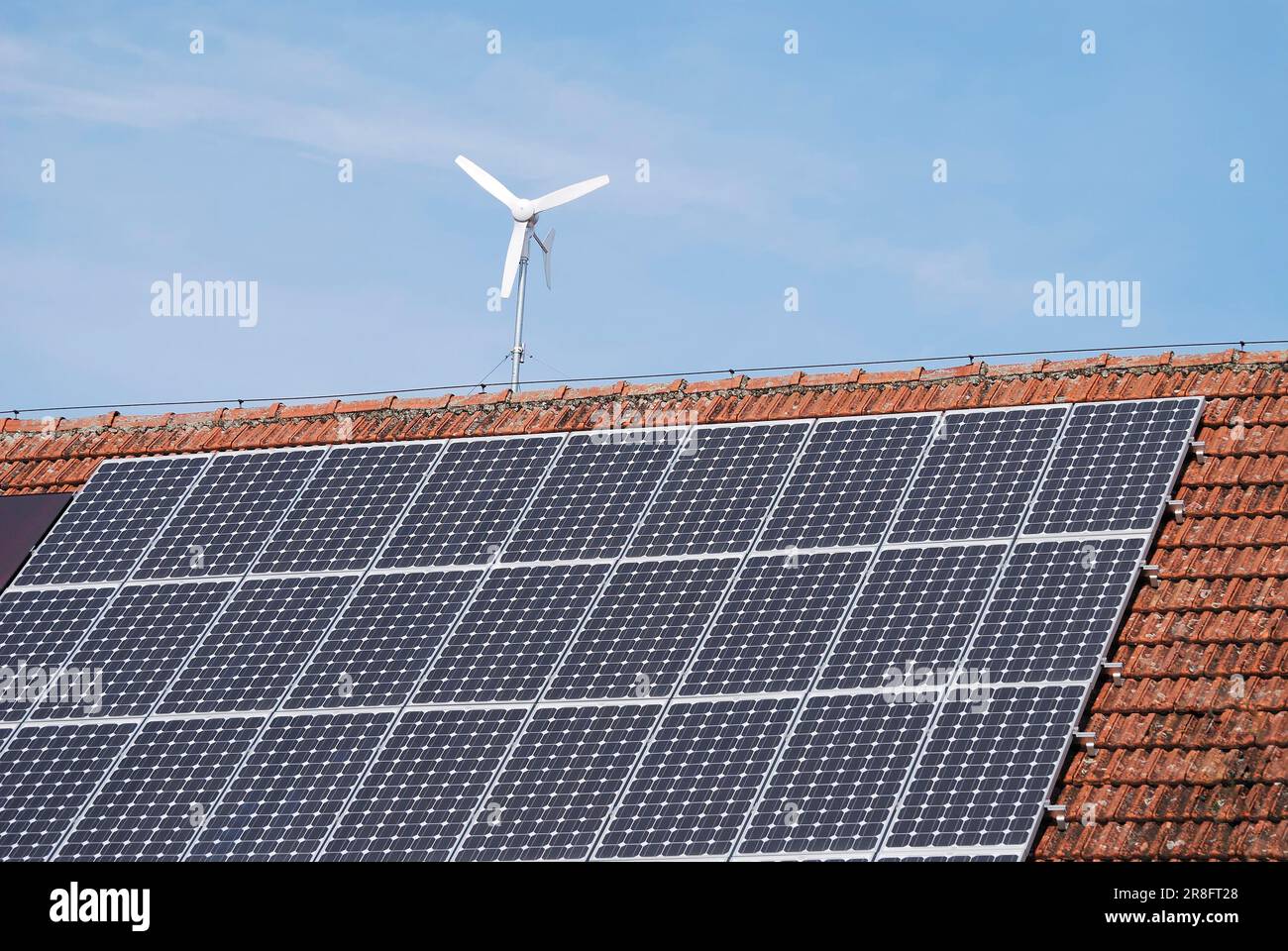 Alternative energy with solar panels and a wind engine Stock Photo