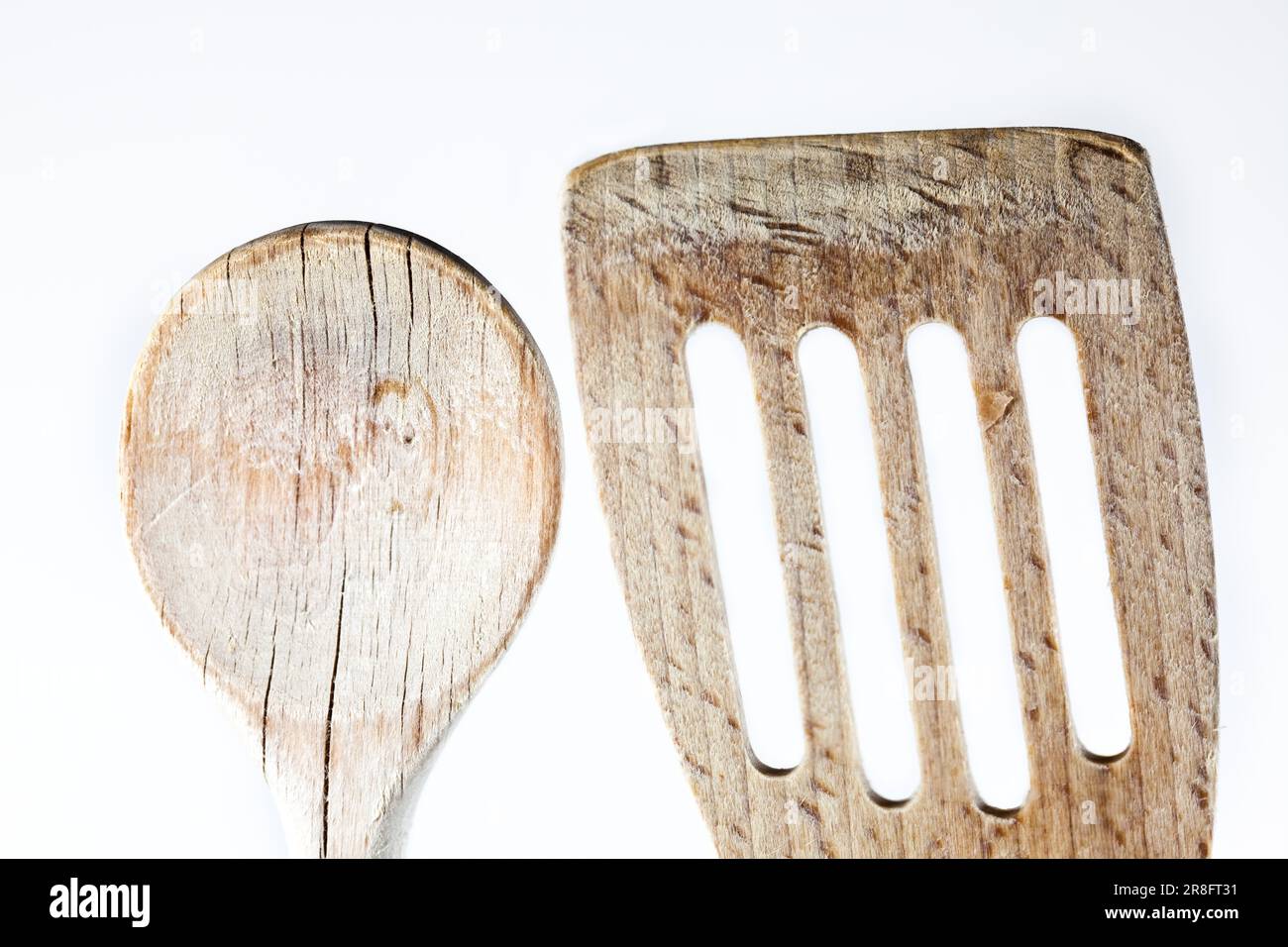 Wooden spoon detail shot against white background Stock Photo
