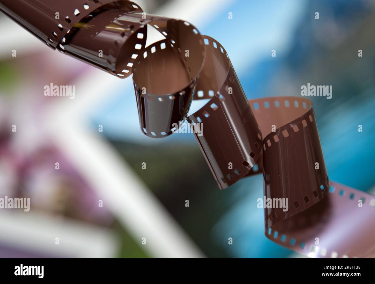 Old camera film strip with photo background Stock Photo - Alamy