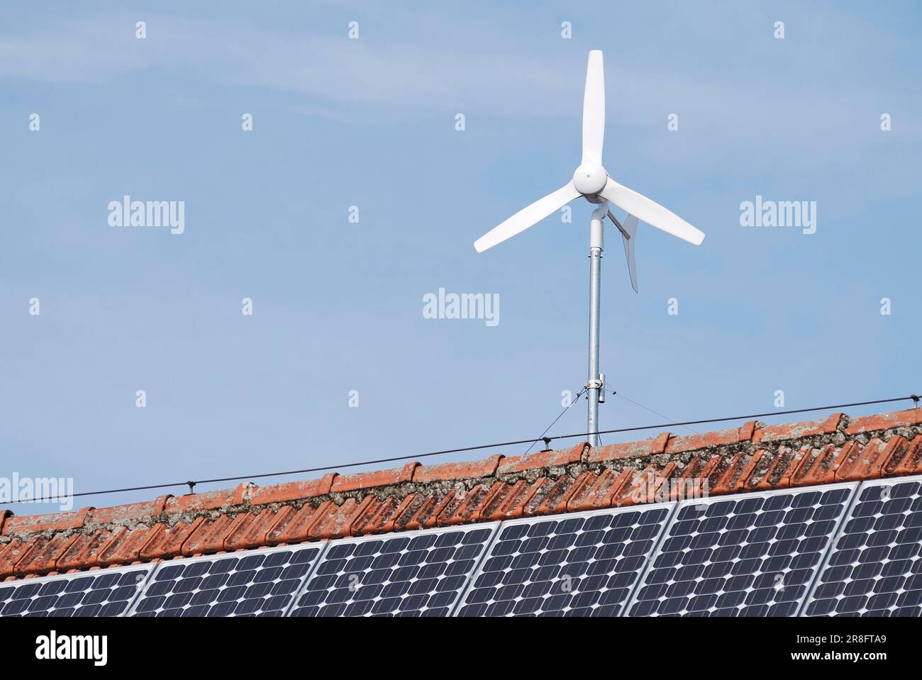 Alternative energy with solar panels and a wind engine Stock Photo