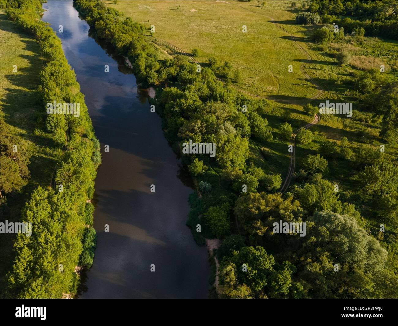 An aerial view of a winding river snaking through lush greenery Stock ...
