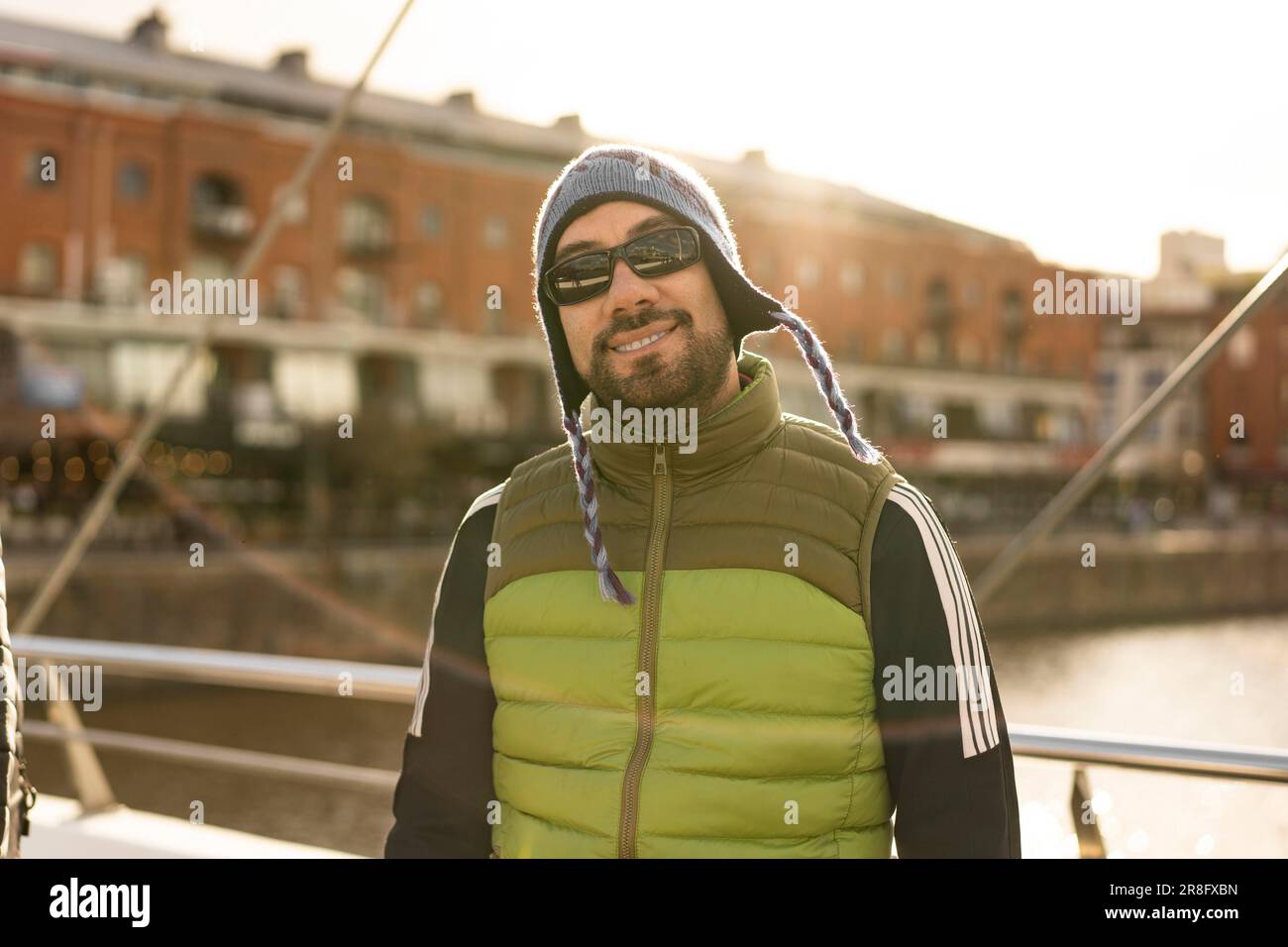 Portrait of a good looking latin man tourist looking at camera in Puerto Madero, Buenos Aires, Argentina Stock Photo