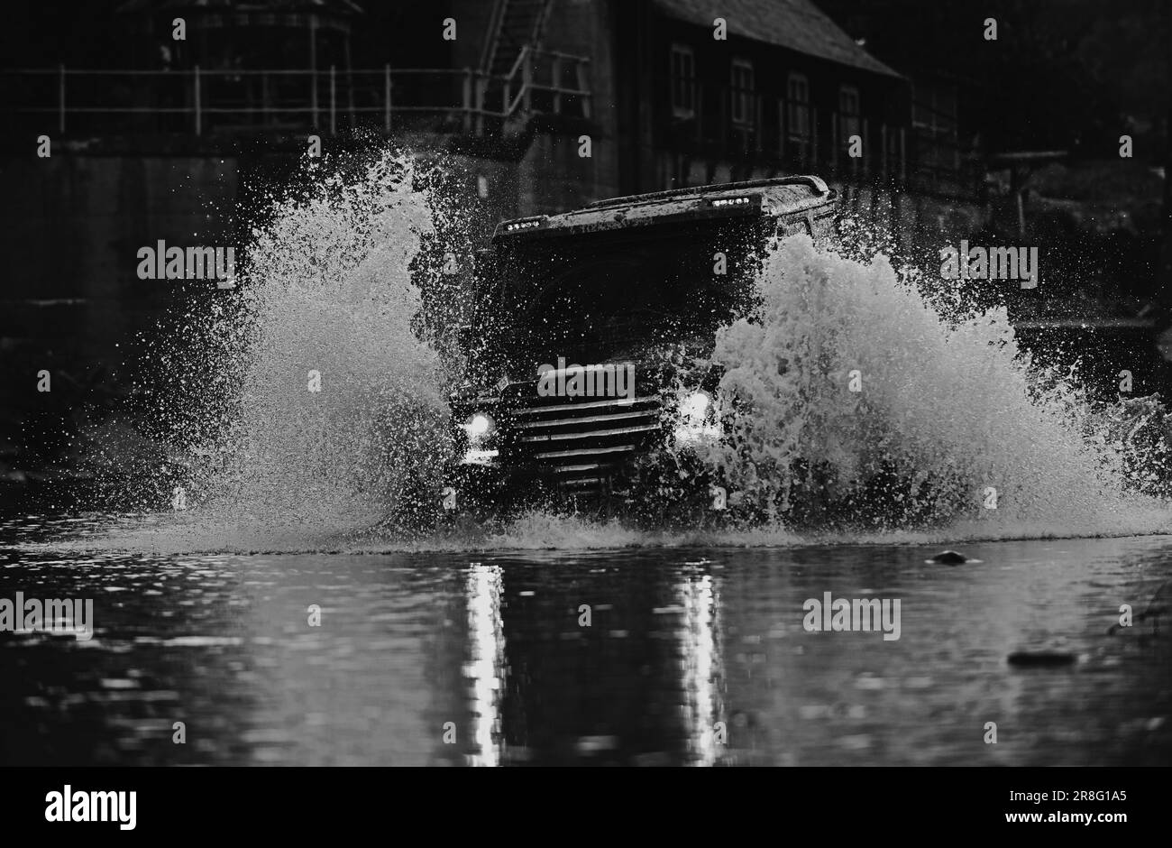 Mud and water splash in off the road racing. Jeep crashed into a puddle