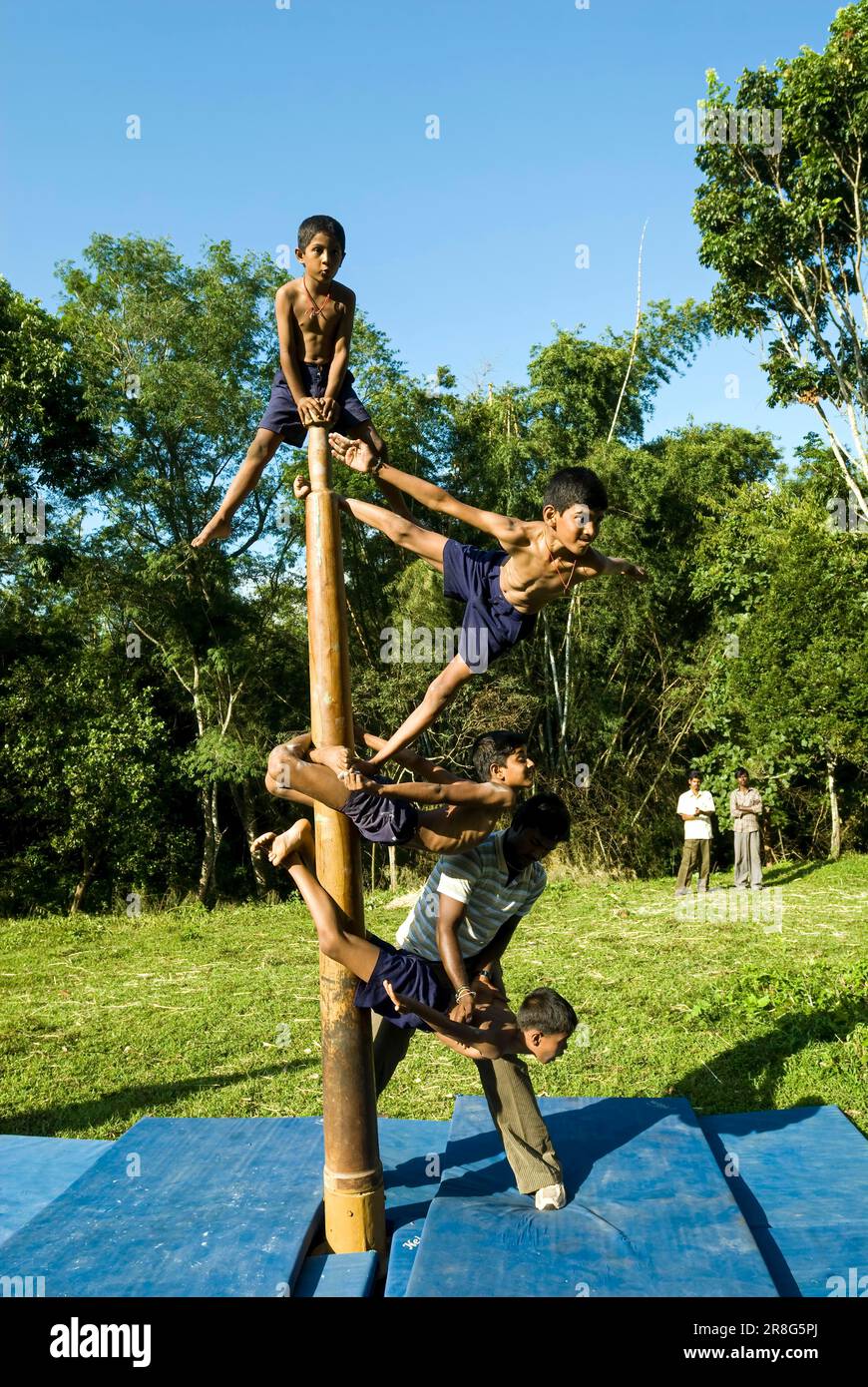 Boy children performing Indian Pole Gymnastics, Mallakhamba mallakhamb