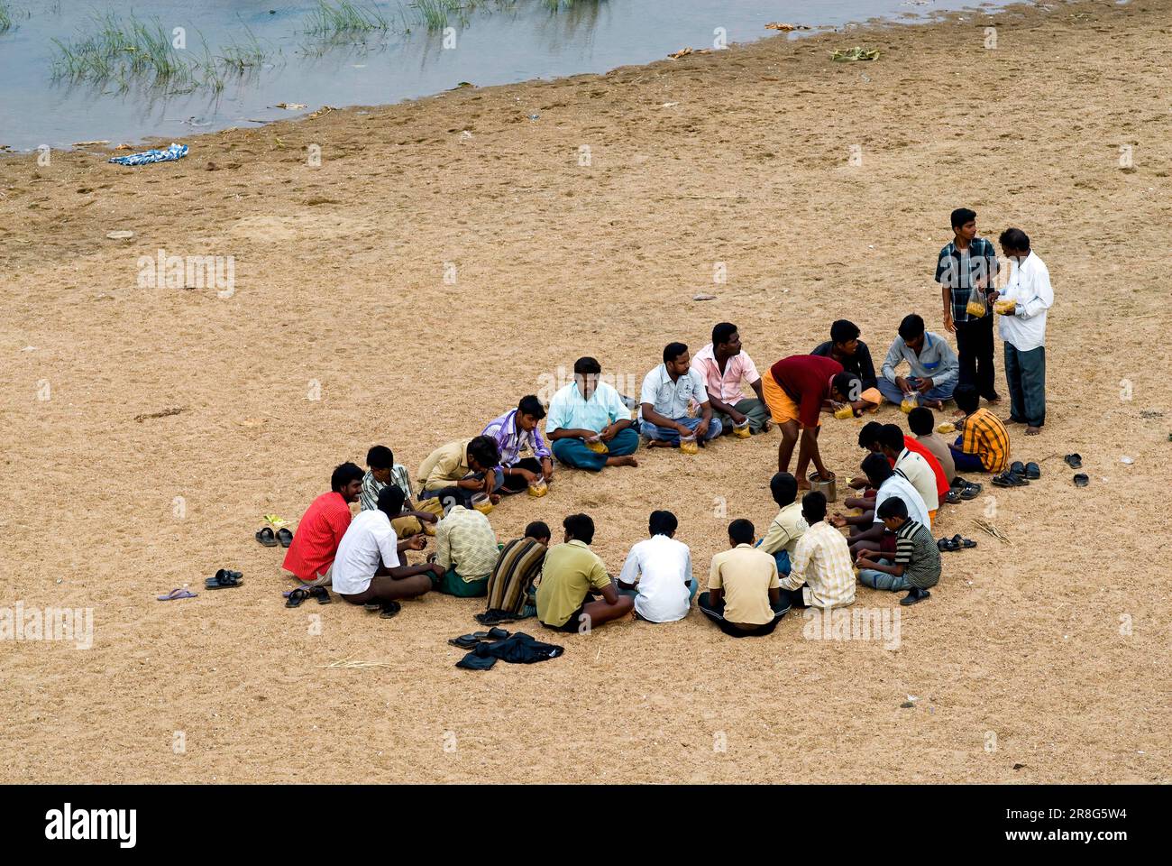 Excursion picnic group sitting and having lunch at Amaravathi river in Dharapuram, Tamil Nadu, South India, India, Asia Stock Photo