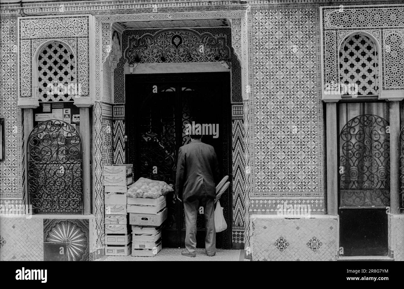 Man entering a mosque with baguettes, France, Paris, 24.03.1990, street ...