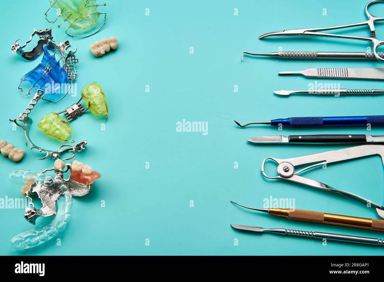Dental Prosthetic Instruments on a Greentoned Workstation Stock Photo