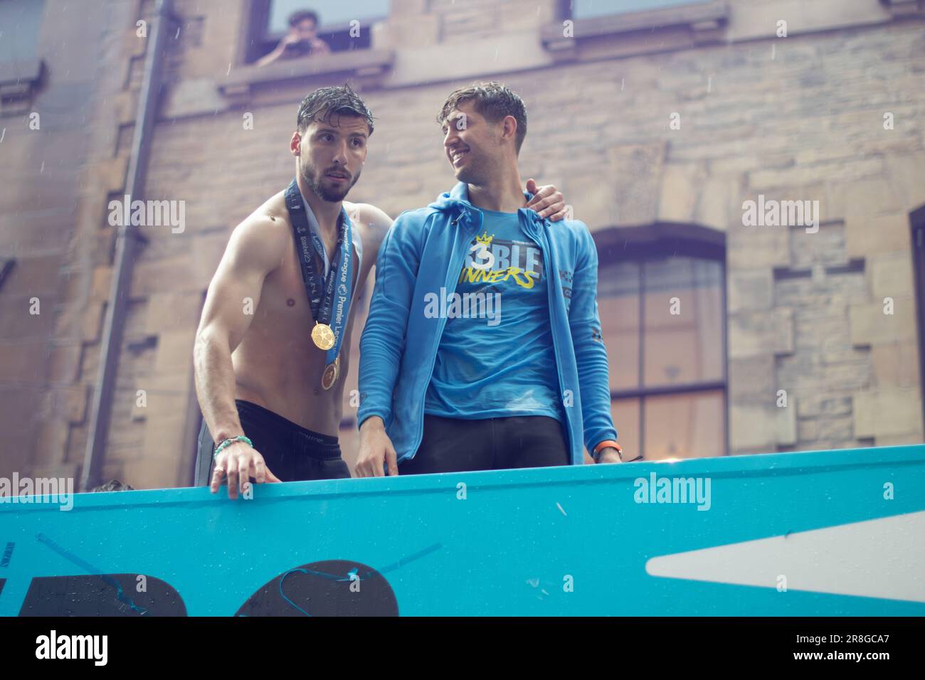 Ruben Dias and John Stones. Manchester City football team open top bus parade during rain. Manchester UK Stock Photo