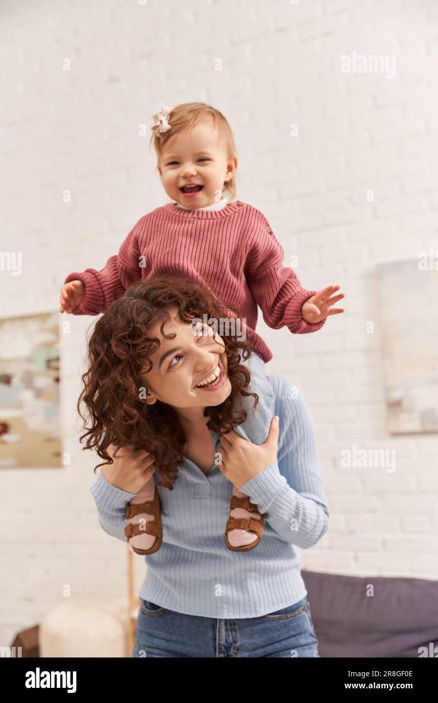 quality time, work and life harmony, cheerful woman with excited baby girl on shoulders, balanced lifestyle, mom daughter time, having fun together, l Stock Photo