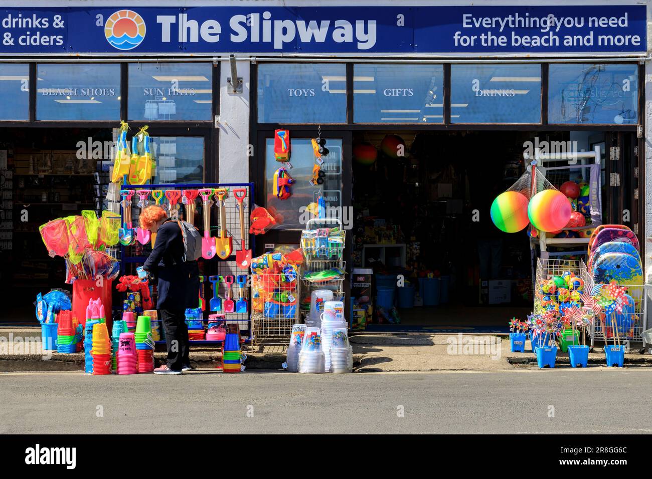 A shop selling colourful beach paraphernalia buckets, spades, balls etc at Lyme Regis on the