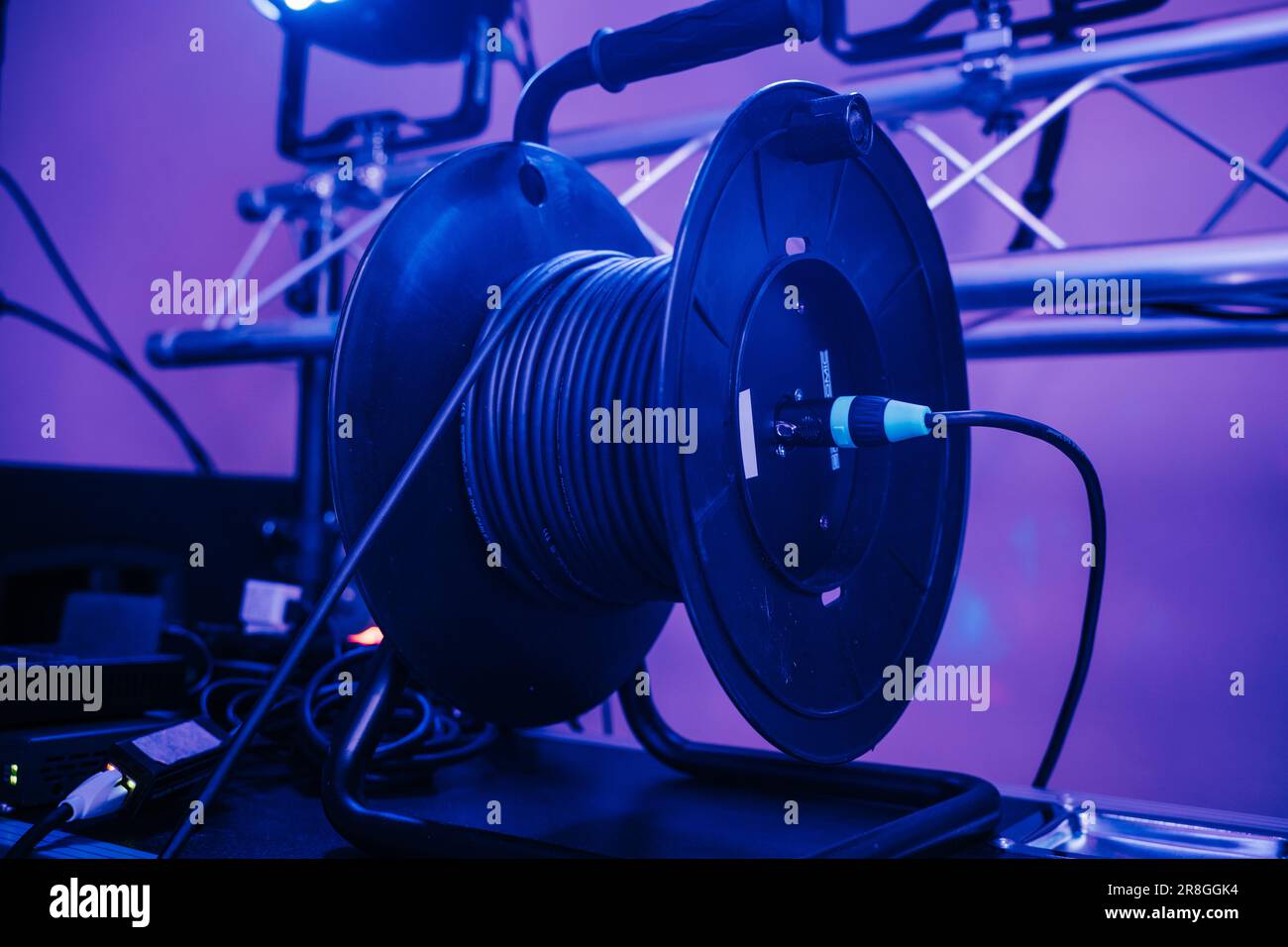 A stage cable reel is situated on a table, supporting a large audio ...