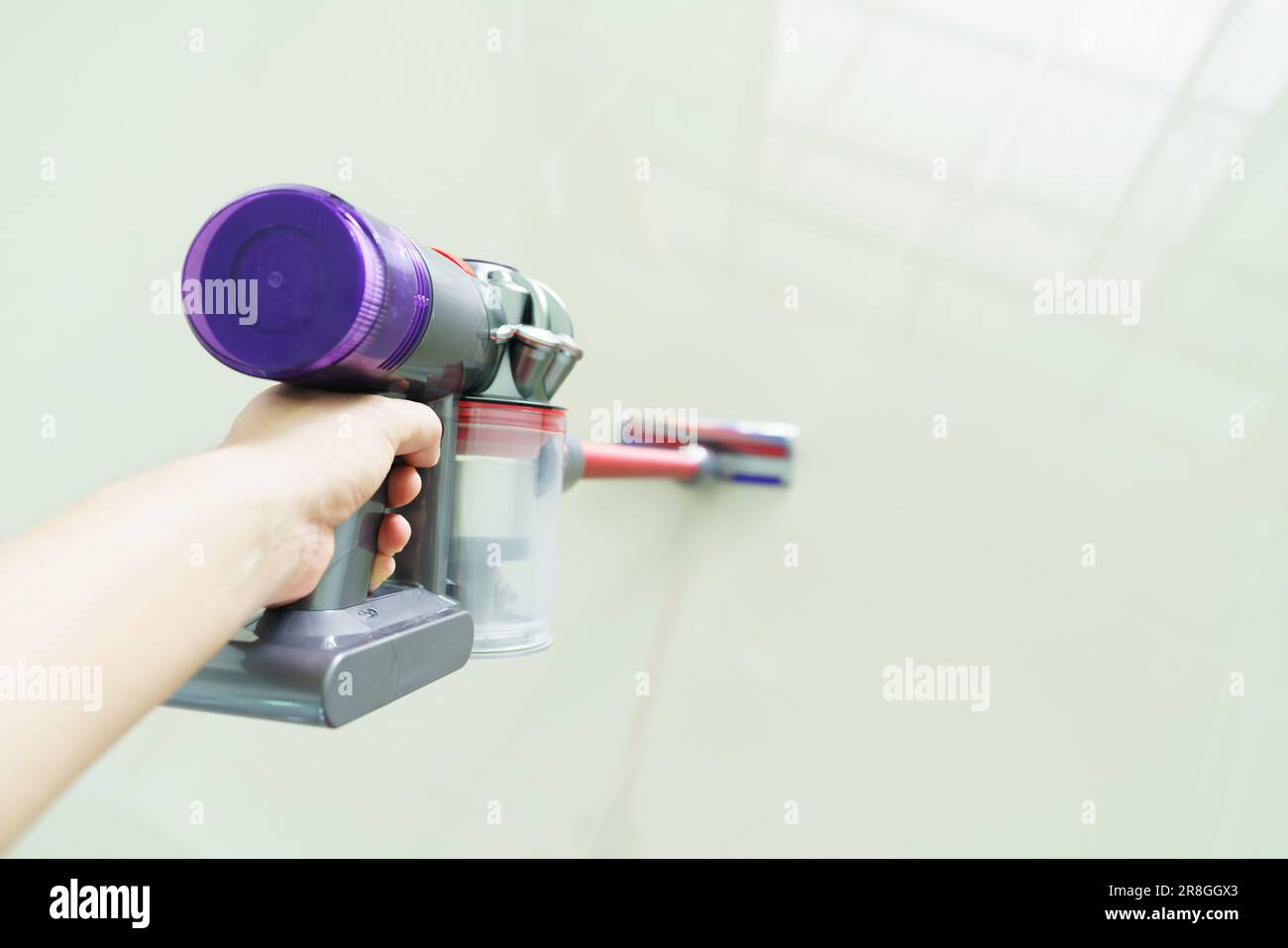 woman clean floor with a vacuum cleaner at home Stock Photo