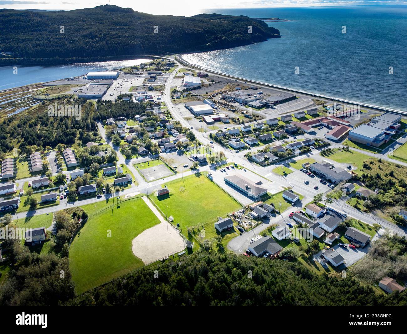 Aerial Newfoundland town of Placentia overlooking baseball diamonds and sports fields with sandy beaches in Atlantic Canada. Stock Photo