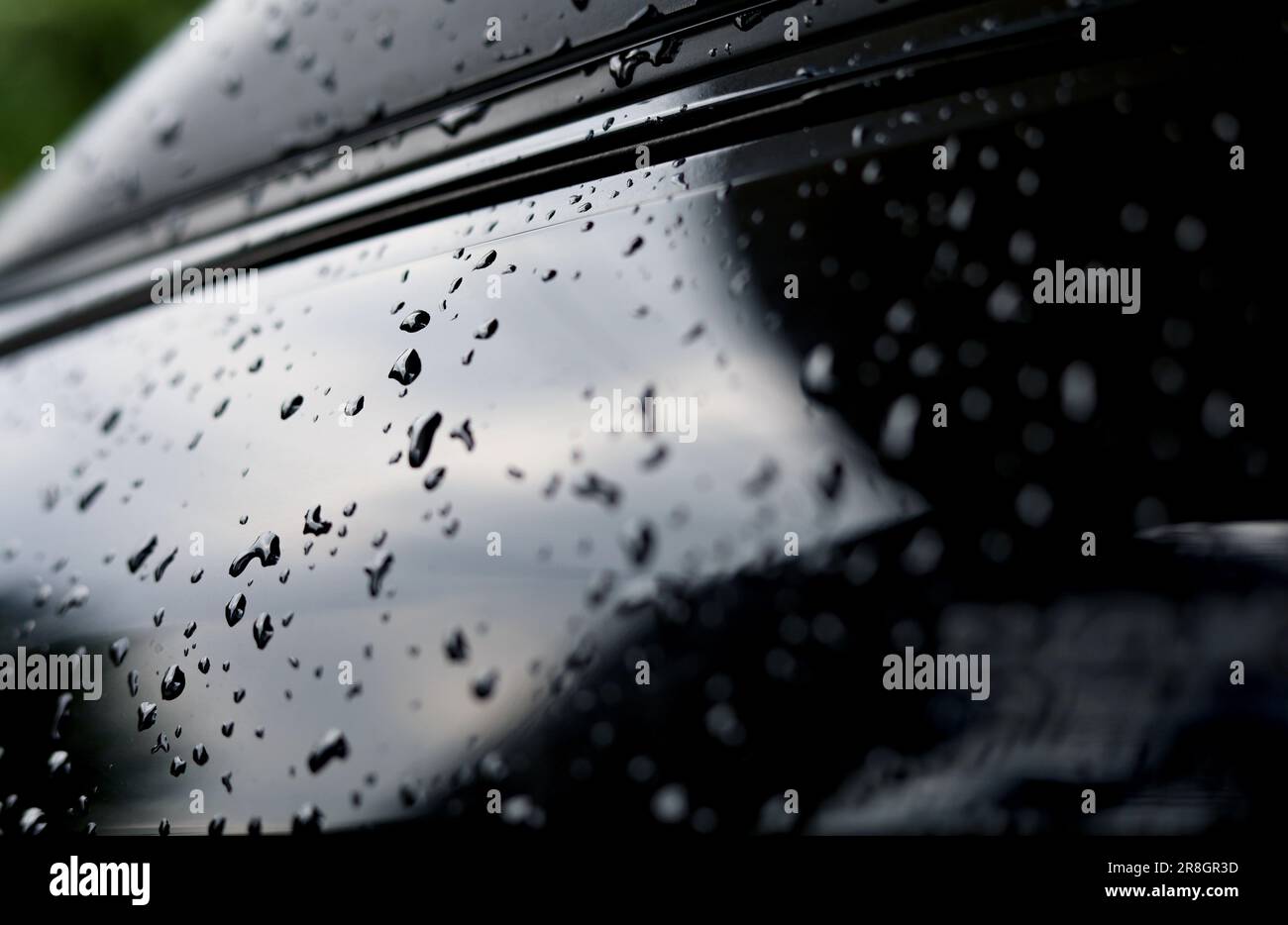 Selective focus of drops water on black metallic car body Stock Photo