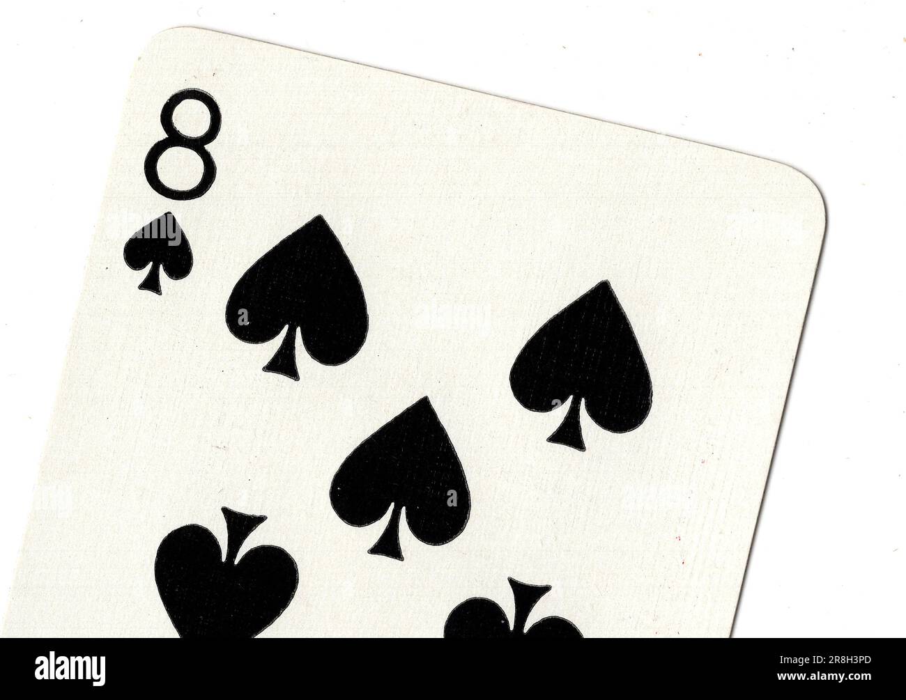 An eight of spades vintage playing card on a white background. Stock Photo