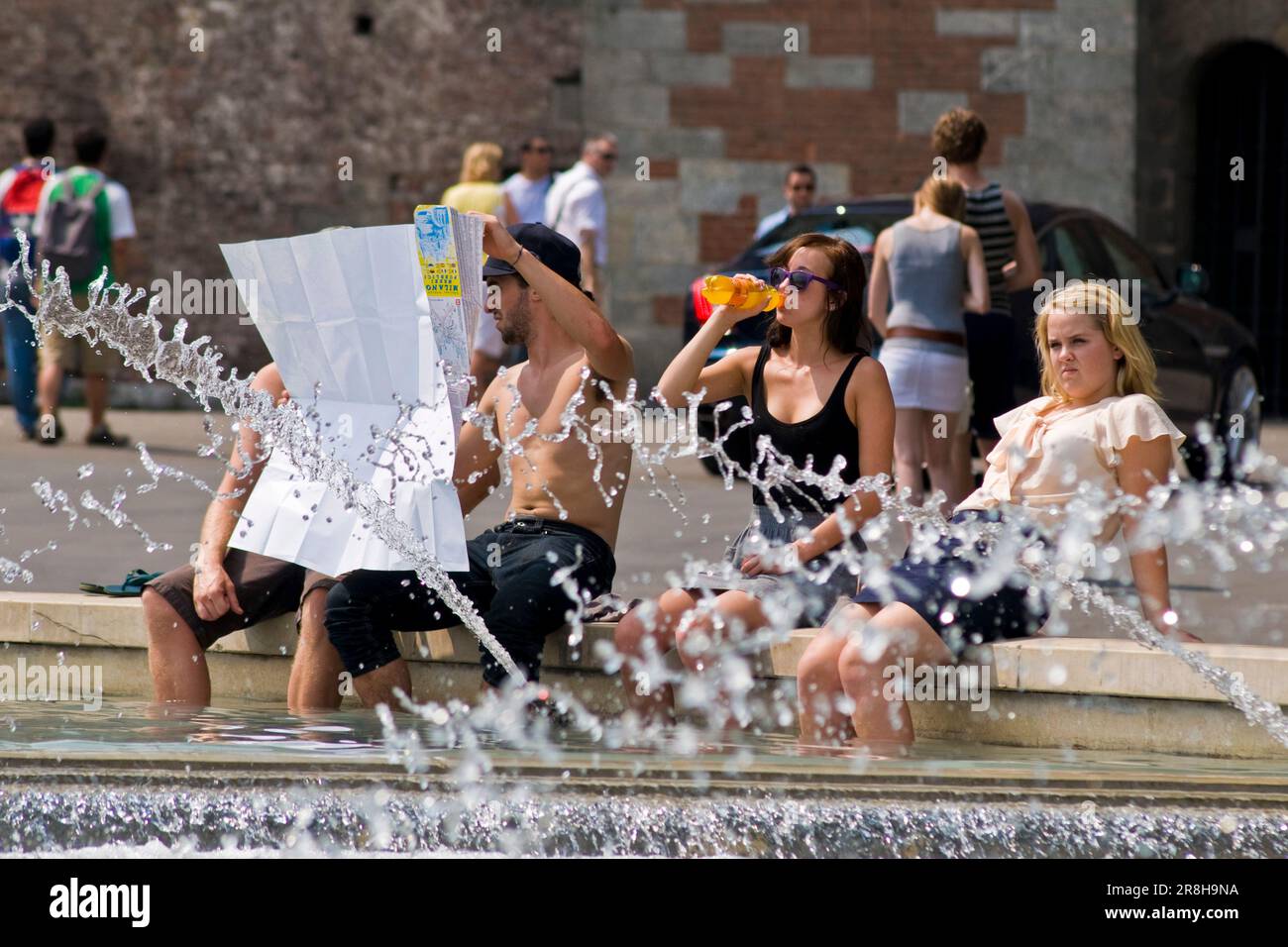 Cooling In the Fountain. Piazza Castello. Milan. Italy Stock Photo
