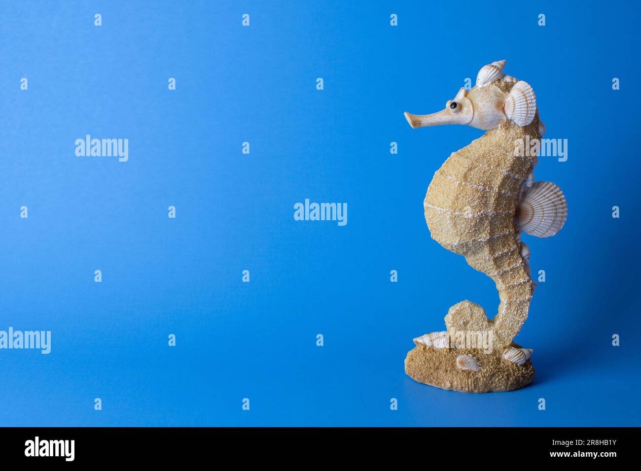 Golden rabbit figurine on the blue background. Free space Stock Photo