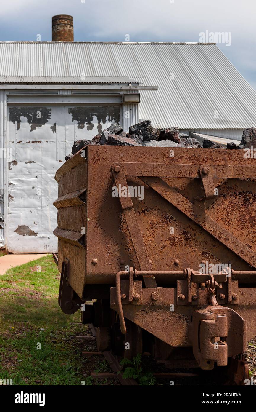Loaded Ore Cart Near Building at Pioneer Mine in Ely Minnesota - abandoned underground mine Stock Photo