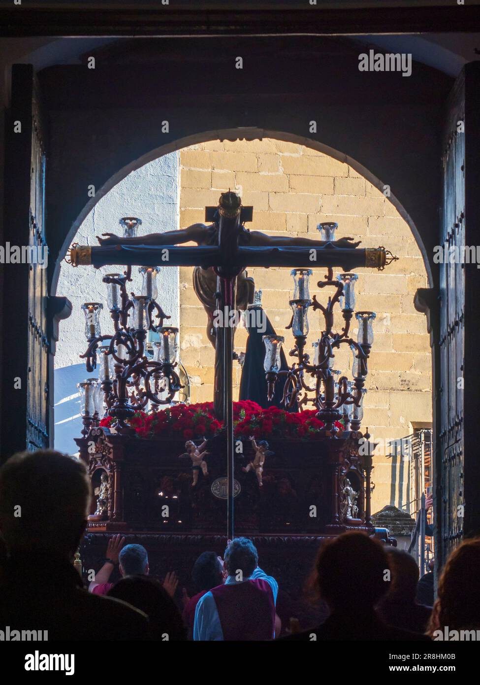 The throne with the figure of Jesus Christ on the cross next to the Virgin Mary, leaving the church during the celebration of the Holy Week in Baeza. Stock Photo