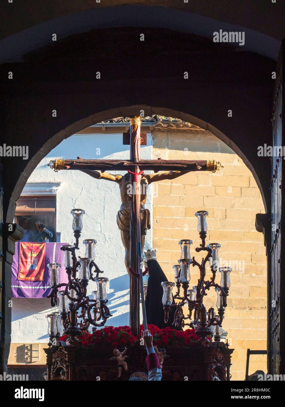 The throne with the figure of Jesus Christ on the cross next to the Virgin Mary, leaving the church during the celebration of the Holy Week in Baeza. Stock Photo