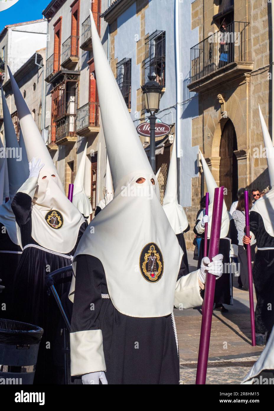 Nazarenes with tunic and hood in the processions in the streets of Baeza during the celebration of its traditional Holy Week. Stock Photo