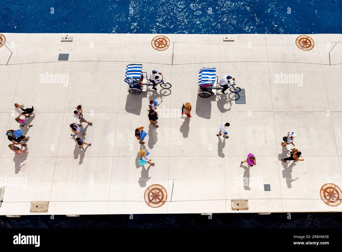 Overhead view of people walking and bicycle taxis at the cruise terminal in Cozumel, Mexico Stock Photo