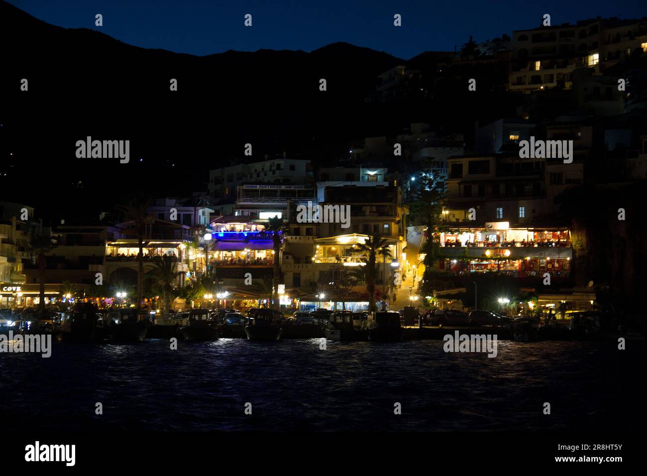 View of Agia Galini, Crete, by night, seen across the harbour Stock Photo