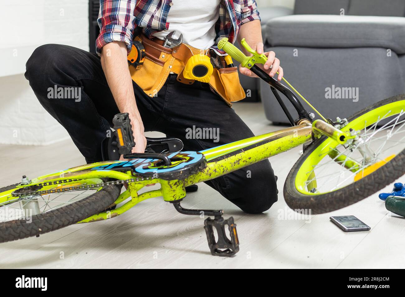 bicycle mechanic adjusting front derailleur mechanism on mountain bike