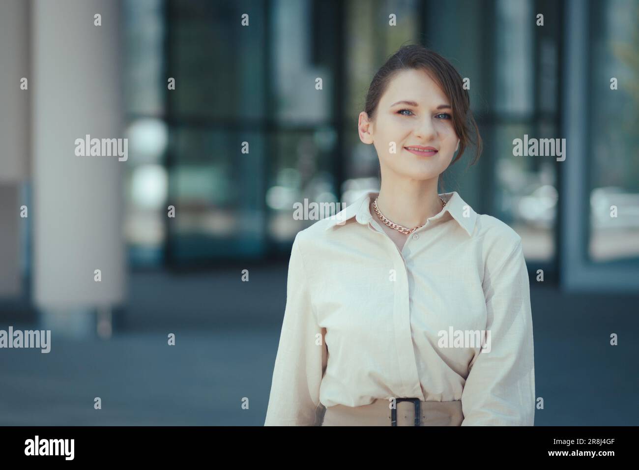 Happy smiling portrait of caucasian female company leader CEO boss executive standing in front of office building Stock Photo