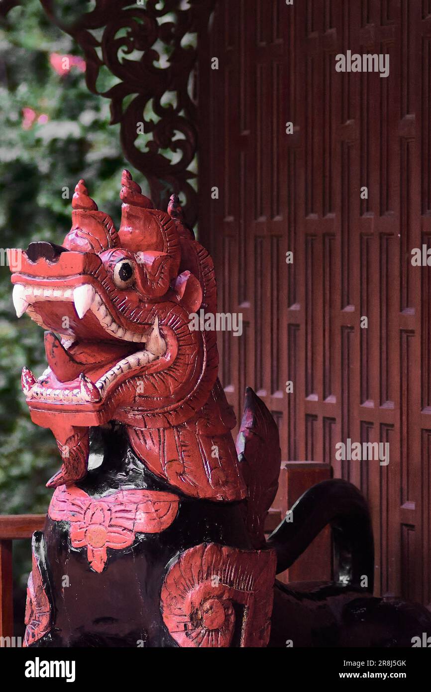 Dragon statue. The Buddhist temple is distinguished by its elaborate sculptures of vivid orange and black colors in Thailand. Stock Photo