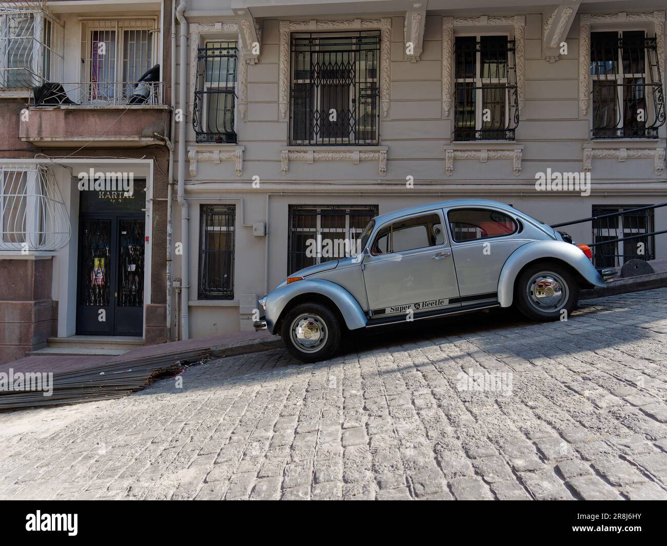 VW Beetle car in silver parked on a steep street in Istanbul, Turkey Stock Photo
