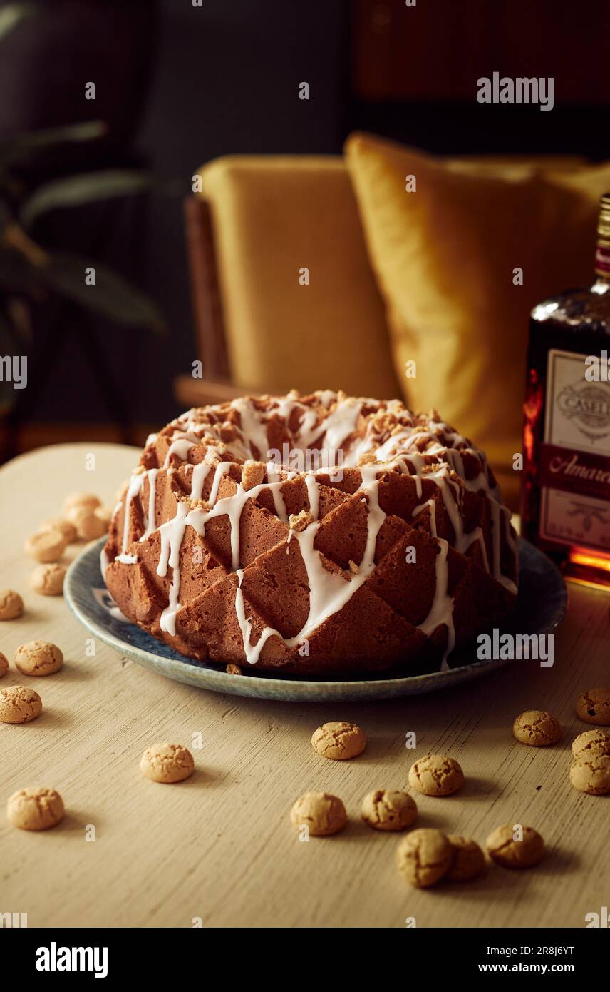 An appetizing three-tier cake is arranged on a table beside two ornate ...