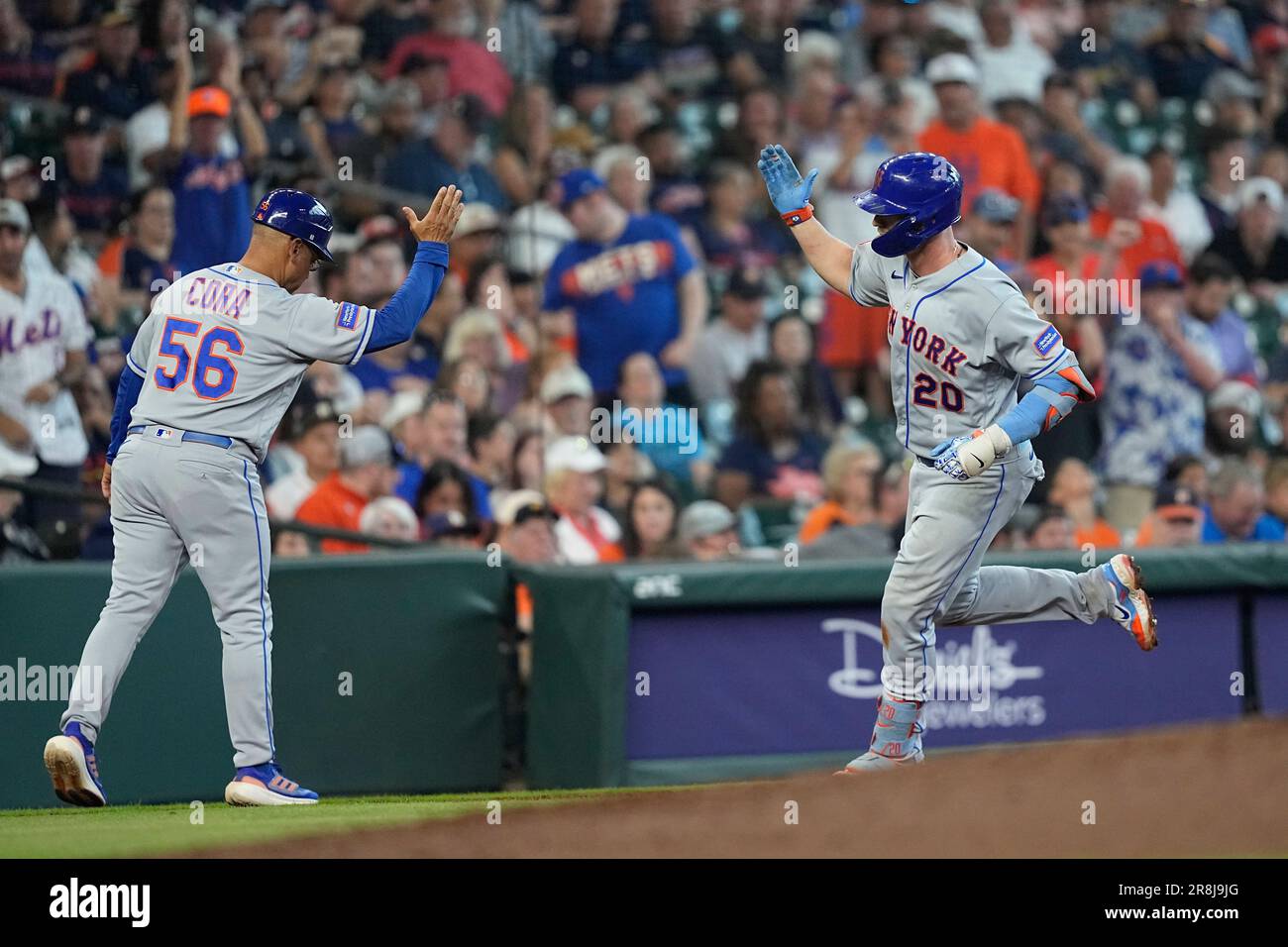 New York Mets' Pete Alonso (20) celebrates with third base coach Joey Cora  (56) after hitting a two-run home run against the Houston Astros during the  sixth inning of a baseball game